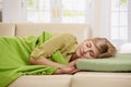 Blond woman sleeping on couch Royalty Free Stock Photo