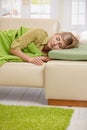 Blond woman sleeping on couch Royalty Free Stock Photo