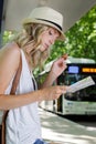 blond woman smoking at bus stop