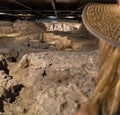 Blond woman with straw hat looking at the ruins and religious wall paintings and frescoes of the saints and the passion of Christ