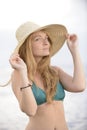 Blond woman with sunhat on the beach Royalty Free Stock Photo