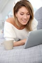 Blond woman with tablet websurfing Royalty Free Stock Photo