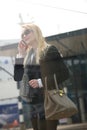 Blond woman talking on mobile phone outdoors Royalty Free Stock Photo