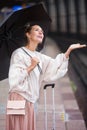 Blond woman with umbrella at train station Royalty Free Stock Photo