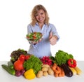 Blond woman with vegetables and green salad showing thumb