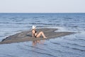 Blond woman wear bikini sitting on a heart shape sand Royalty Free Stock Photo