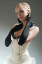 Blond woman in white dress and black gloves