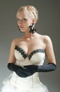 Blond woman in white dress and black gloves