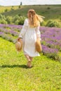 Blond woman in white summer dress walking away Royalty Free Stock Photo