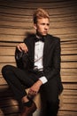 Blond young elegant man sitting on a chair Royalty Free Stock Photo