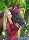 Blond young equestrian model with horse Royalty Free Stock Photo