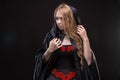 Blond young girl in black cloak Royalty Free Stock Photo