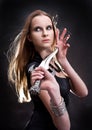 Blond young girl holding dagger Royalty Free Stock Photo