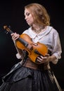 Blond young girl looking at violin Royalty Free Stock Photo
