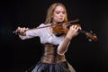 Blond young girl playing the fiddle Royalty Free Stock Photo