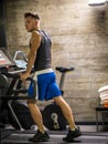 Blond young muscular man running on treadmill in gym Royalty Free Stock Photo