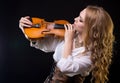 Blond young woman looking at violin Royalty Free Stock Photo