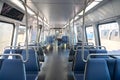 Blonde adult woman in an empty Washington subway train wearing blue jeans while waving her hand out the window Royalty Free Stock Photo