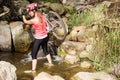 Blonde athlete carrying her mountain bike over stream Royalty Free Stock Photo