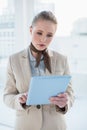 Blonde attractive businesswoman holding tablet