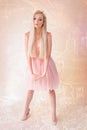 Blonde Attractive Woman, with Very Big Blue Eyes and Long Hair, with a Lace and Tulle Dress, on Pattern Pink Background Royalty Free Stock Photo