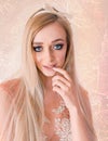 Blonde Attractive Woman, with Very Big Blue Eyes and Long Hair, with a Lace and Tulle Dress, Touching Her Lips, on Pattern Pink Royalty Free Stock Photo