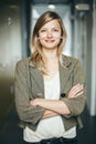 Blonde authentic businesswoman with crossed arms smiling Royalty Free Stock Photo