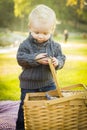 Blonde Baby Boy Opening Picnic Basket Outdoors at the Park Royalty Free Stock Photo