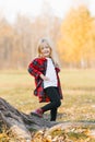 Blonde baby girl smiling in autumn Park. Walk in the day Royalty Free Stock Photo