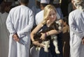 Blonde with a baby goat at habit market in Nizwa