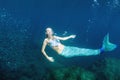 Blonde beautiful Mermaid diver underwater