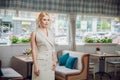 Blonde beautifull businesswoman posing in a restaurant