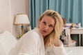 Blonde beauty cell bed copyspace spa female bathrobe care untying, from ritual cropped for home from beautiful Royalty Free Stock Photo