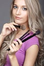 Blonde beauty female stylist - visagist with makeup brushes