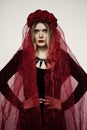 Blonde in a black dress and red veil. Gothic bride Royalty Free Stock Photo