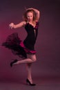 Blonde, in black Spanish Dressdress flamenco dancer in action, on a Burgundy background of the Studio Royalty Free Stock Photo