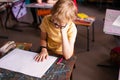 Blonde boy with glasses drawing. Group of elementary school pupils in classroom on art class. Russia, Krasnodar, May, 23, 2019