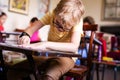 Blonde boy with glasses drawing. Group of elementary school pupils in classroom on art class. Russia, Krasnodar, May, 23, 2019