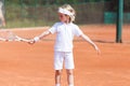 Blonde boy practicing tennis Royalty Free Stock Photo