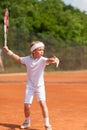 Blonde boy practicing tennis Royalty Free Stock Photo