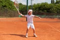 Blonde boy practicing tennis Royalty Free Stock Photo