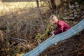 Blonde boy sliding down a playground slide Royalty Free Stock Photo