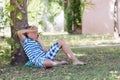 A blonde boy talking on his phone in park Royalty Free Stock Photo