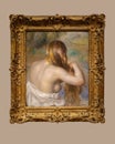 Blonde Braiding Her Hair by Pierre-Auguste Renoir on display in the Dallas Museum of Art.