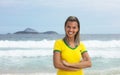 Blonde brazilian sports fan with crossed arms at beach Royalty Free Stock Photo