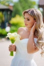 a blonde bride with bouquet Calla Lily in a white dress. wedding fashion