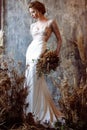 Blonde bride in fashion white wedding dress with makeup