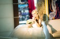 Blonde bride sitting on the armchair in room Royalty Free Stock Photo