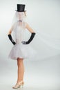 Blonde bride in tophat with veil and long black gloves