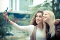 Blonde and brunette beautiful stylish young women Royalty Free Stock Photo